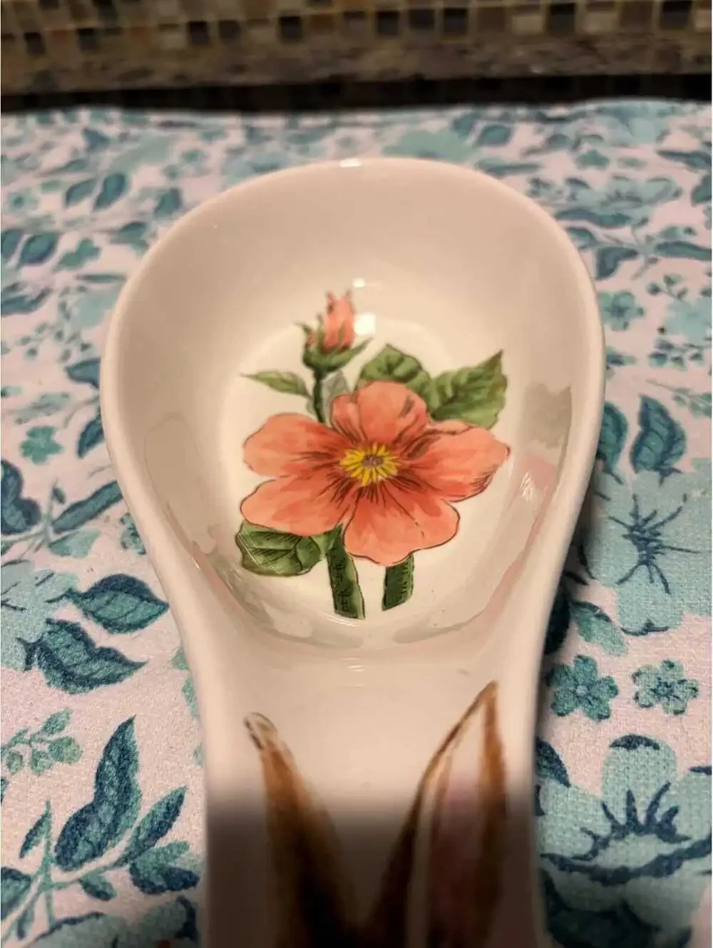 This is a Maxcera ceramic spoon rest featuring a rabbit and pink flowers.